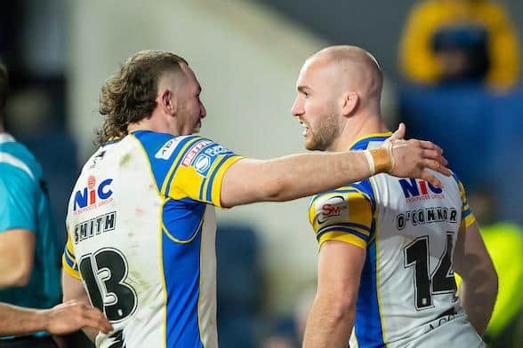 Jarrod O'Connor is congratulated by Cameron Smith after scoring for Leeds Rhinos against Huddersfield Giants. Picture by Allan McKenzie/SWpix.com.
