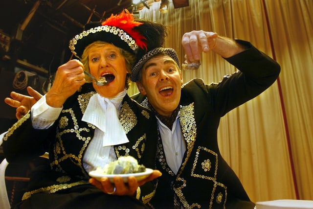 Gary Holmes and Marjorie Inman, the Pearly King and Queen at Guiseley Amateur Operatic Society's production of 'Me And my Girl' try the delights of jellied eelsin February 2003 which had been specially shipped north from London's East End, to be sold to the audiences.
.