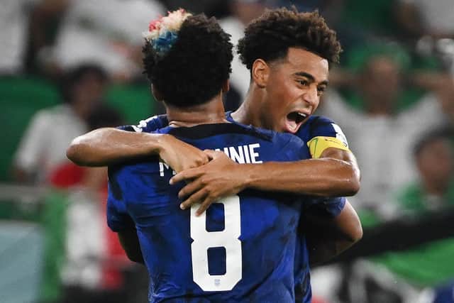 GOING THROUGH! Leeds United's Tyler Adams, right, hugs USA team mate Weston McKennie after the Christian Pulisic winner against Iran. 
Photo by PATRICK T. FALLON/AFP via Getty Images