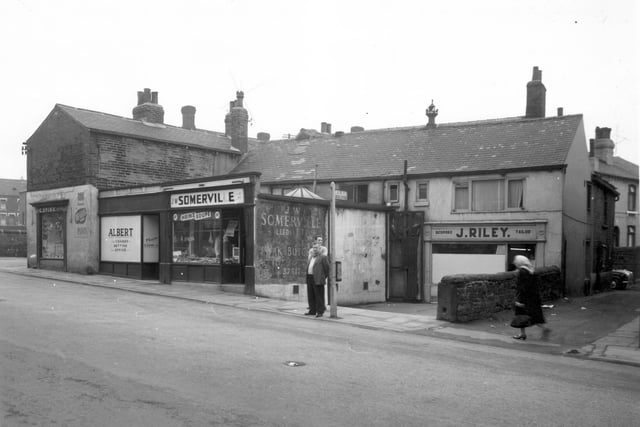 On the left is Craven Road, the wall which is just visible was the perimeter wall for Woodhouse Street school playground. Moving right, C. Spink decorator and plumber's business is at 2 Craven Road with a window onto Woodhouse Street. Next is 74c Woodhouse Street 'Albert' a licenced betting office. J. W. Somerville had a pork butchers shop at 74a, locally farmed for pork dripping (also called mucky fat) and pork pies. Set back is a tailors business run by J. Riley, this was 74b. On the right side is Nether Row.