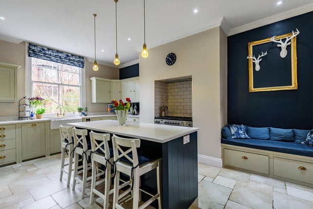 The bespoke kitchen was designed by Neptune and benefits from a lifetime guarantee, with stylish wall and base units and a central island, high specification integrated appliances and underfloor heating.