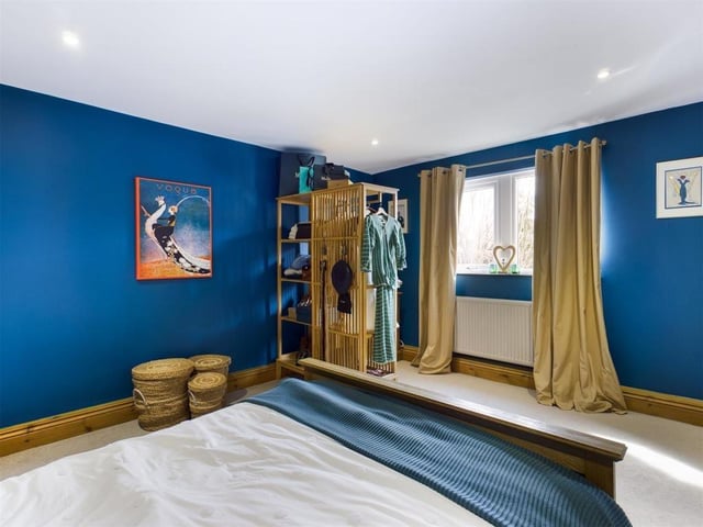 A carpeted bedroom which demonstrates size and space.