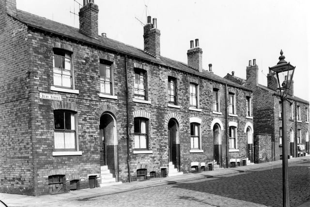 A row of back-to-back terraced houses on Ruby Street separated between numbers 7 and 9 by a row of shared outside toilets. This area was known locally as Newtown. Pictured in September 1959.