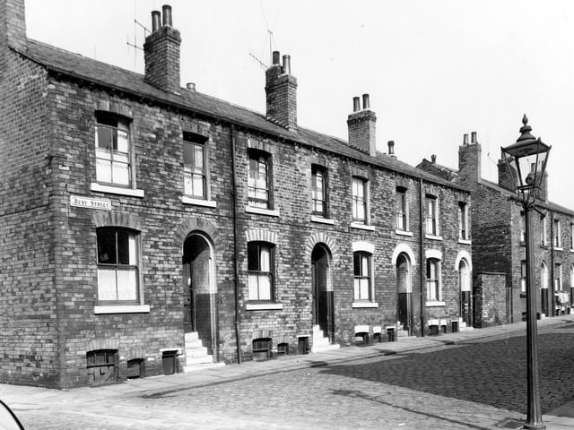 A row of back-to-back terraced houses on Ruby Street separated between numbers 7 and 9 by a row of shared outside toilets. This area was known locally as Newtown. Pictured in September 1959.