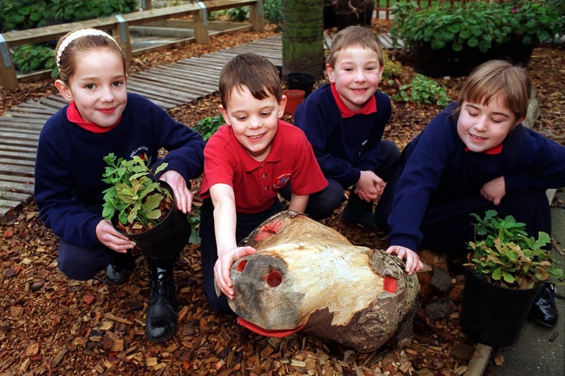 A new outdoor nature garden was opened at Swillington Primary School in December 1996. Some of the pupils are pictured in the garden with a dragon made from an old tree by Sven McLean of the Lower Aire Valley Project Groundwork  Trust. Pictured, from left, are Jennifer Wallwork, Alistair Wbster, Oliver Doubtfire and Fiona Lindley.