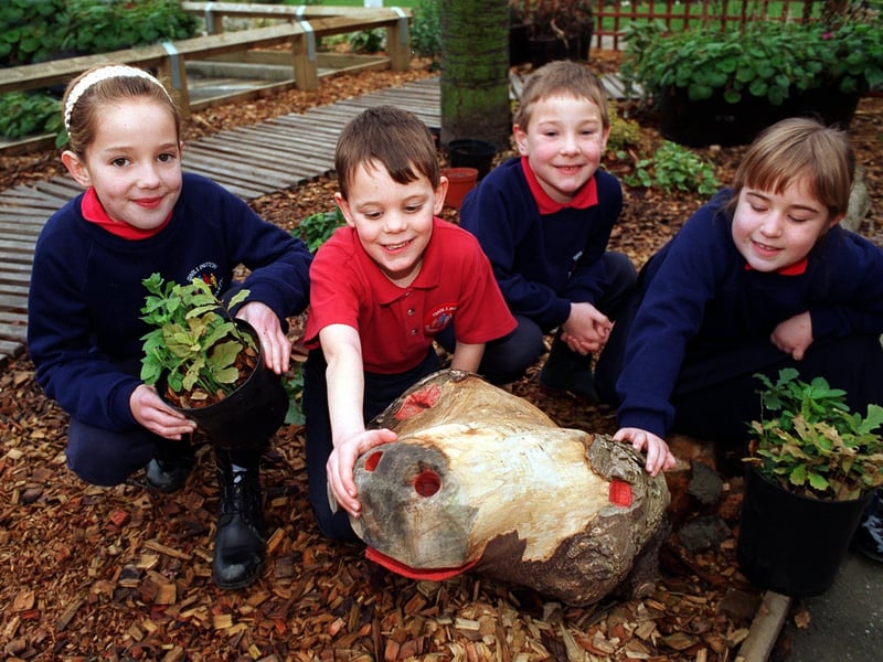 A new outdoor nature garden was opened at Swillington Primary School in December 1996. Some of the pupils are pictured in the garden with a dragon made from an old tree by Sven McLean of the Lower Aire Valley Project Groundwork Trust. Pictured, from left, are Jennifer Wallwork, Alistair Wbster, Oliver Doubtfire and Fiona Lindley.