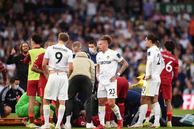 Leeds United's Dutch defender Pascal Struijk (2nd R) looks on as Liverpool's English striker Harvey Elliott is treated for a serious leg injury following a tackle during the English Premier League football match between Leeds United and Liverpool at Elland Road in Leeds, northern England on September 12, 2021.