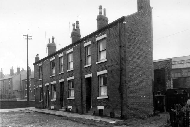 The view on the left looks up Rothsay Place, across Little Town Lane to Lansdowne Mount Rothsay Place has an unsurfaced road in September 1960. Behind the houses is a yard area with sheds and out buildings also industrial premises used by Waterhouse's toffee makers and Northern Chairworks.