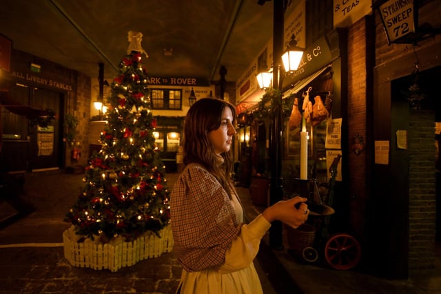 Pictured is Alice Macpherson by the Christmas tree on the Victorian streets at Abbey House Museum in Kirkstall, Leeds.