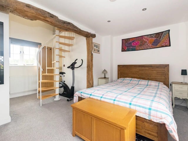 To the first floor is a master bedroom with windows to front and rear, downlights and exposed oak beams.