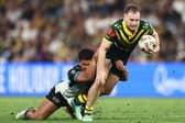 Sam Walker is tackled during his debut for Australia in the World Cup win over Fiji in Brisbane on Sunday. Picture by Chris Hyde/Getty Images.