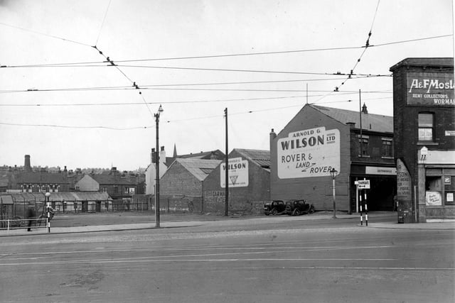 Chapeltown Road at junction with Sheepscar Street North in July 1957. Meanwood Road in background. 'Arnold Wilson's Garage' and 'Mosley's Rent Collectors' visible.