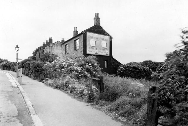 Leeds and Bradford Road with Shell billboard at gable end in July 1951. Near or above Moorside Estate outfall sewer.