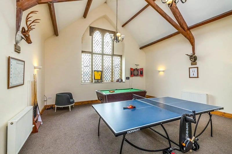 With a spectacular full height original window and original beams, this space is currently used as a games room although it could make a spectacular reception or dining room, says the brochure.