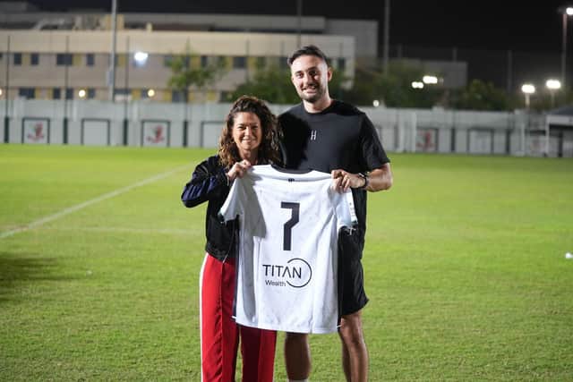 Jo Plinston, Titan Wealth, and Rob Shotton, LooseHeadz, showcase the Titan Wealth-sponsored LooseHeadz shirt at the Dubai 7s tournament in November 2024