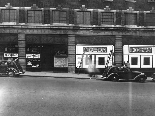The Odeon Cinema pictured in April 1942. It was opened on February 22, 1932 as the Paramount, name change to Odeon in 1940. The entrance was at the junction with New Briggate. This view shows side of building and number 16 John Thorntons Chocolate Kabin. The cinema was designed by Frank T. Verity and seated 2,590. The design was structured to fit with the unified look of The Headrow,