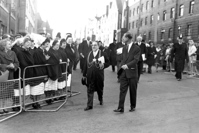 The Duke of Edinburgh walks with the Lord Mayor, Alderman P Woodward after opening the Martin Wing and Link Block Laboratories at Leeds General Infirmary in November 1961. A crowd had gathered to see the Duke who is seen talking to nursing staff. Accompanying the Duke of Edinburgh and the Mayor was the Lady Mayoress, Sir George Martin and Sir Charles Morris, Vice Chancellor of the University of Leeds.