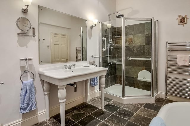 This en suite bathroom has a free standing bath and a separate shower cubicle.