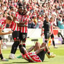 HELPING HAND: From Brentford as the Bees celebrate Josh Dasilva's winner. Photo by Ryan Pierse/Getty Images.