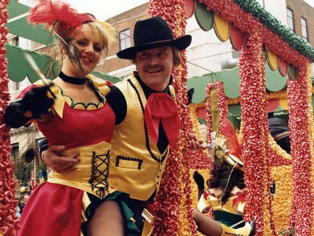 Lewis's staff pose on a decorated float. Staff dressed as characters from the Wild West.