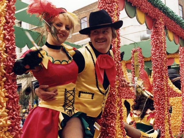 Lewis's staff pose on a decorated float. Staff dressed as characters from the Wild West.