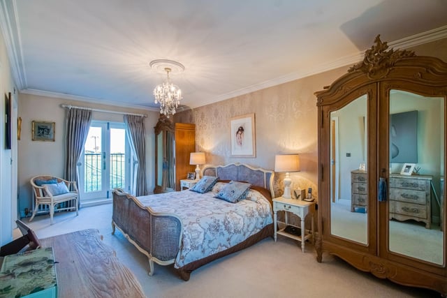 This spacious bedroom has French doors that open to a Juliet balcony, overlooking fields to the rear.