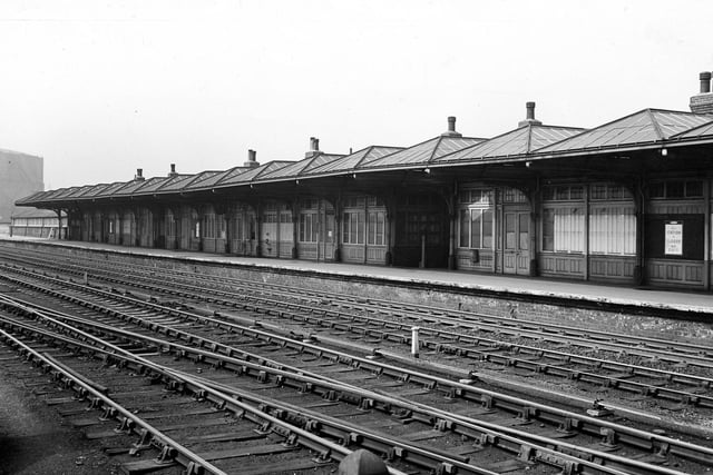 A view of Holbeck high level railway station, one of two levels of Holbeck Station, which crossed each other via a bridge. Both levels opened in July 1855 and closed in July 1958, the year before this photograph was taken; a notice on the window on the right says 'This station is closed'. Pictured in April 1959.