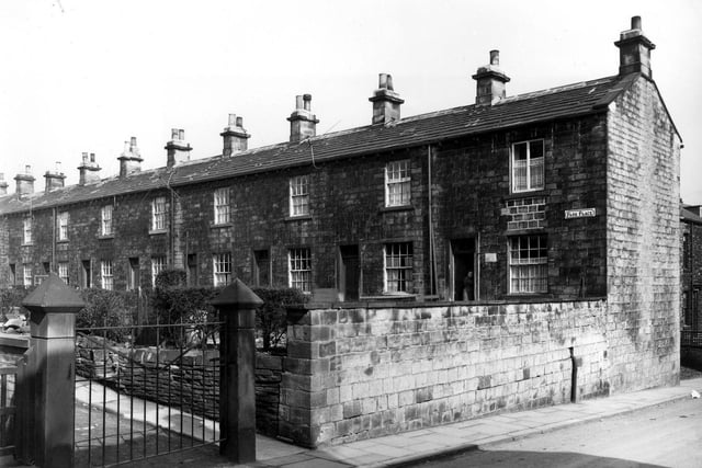 An iron gate flanked by stone gate posts on Bell Lane has access to Park Place. This is a row of 'through-by-light' cottages with front gardens. There are fourteen dwellings in the row. Pictured in April 1960.