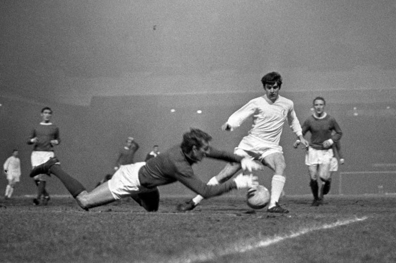 Manchester United goalkeeper Alex Stepney (second l) saves at the feet of Leeds United's Peter Lorimer (second r) as Manchester's Francis Burns (l) and Carlo Sartori (r) look on Issue date: