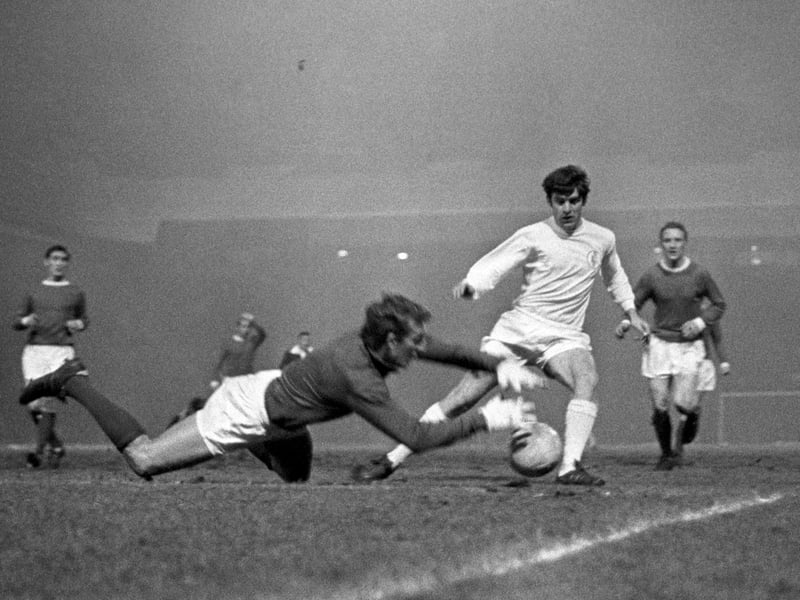 Manchester United goalkeeper Alex Stepney (second l) saves at the feet of Leeds United's Peter Lorimer (second r) as Manchester's Francis Burns (l) and Carlo Sartori (r) look on Issue date: