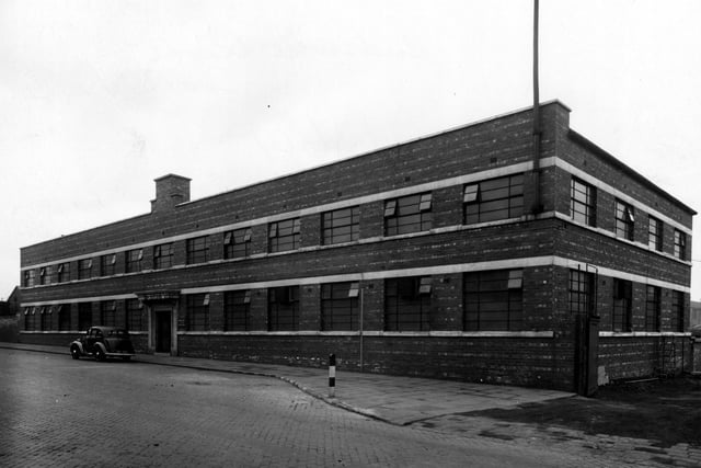 The premises of Hudswell, Clarke and Co engineering specialists on Jack Lane pictured in March 1943. The building is brick built, two storey with rows of windows on each floor. A car is parked outside the main entrance. There is a works entrance to the right.