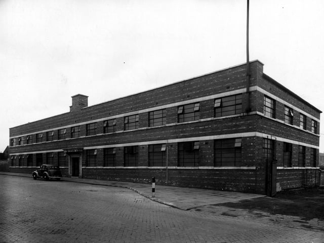 The premises of Hudswell, Clarke and Co engineering specialists on Jack Lane pictured in March 1943. The building is brick built, two storey with rows of windows on each floor. A car is parked outside the main entrance. There is a works entrance to the right.