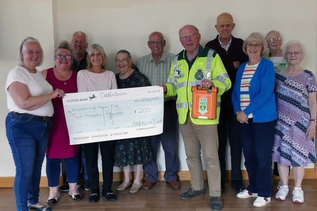 Rotarian Jonathan Beer receiving the Oddfellows cheque from Helen Bullock (second from left).