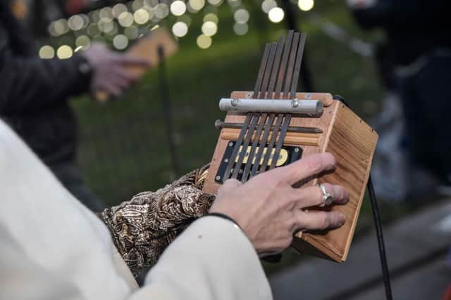 Participants participate in an ephemeral thumb-piano parade through Madison Square Park in New York City (Photo: Kris Connor/Getty Images for Make Music Winter)