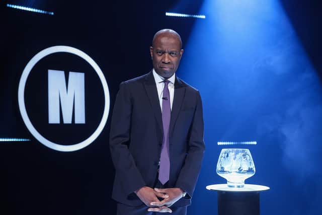 Host Clive Myrie with Mastermind glass bowl trophy