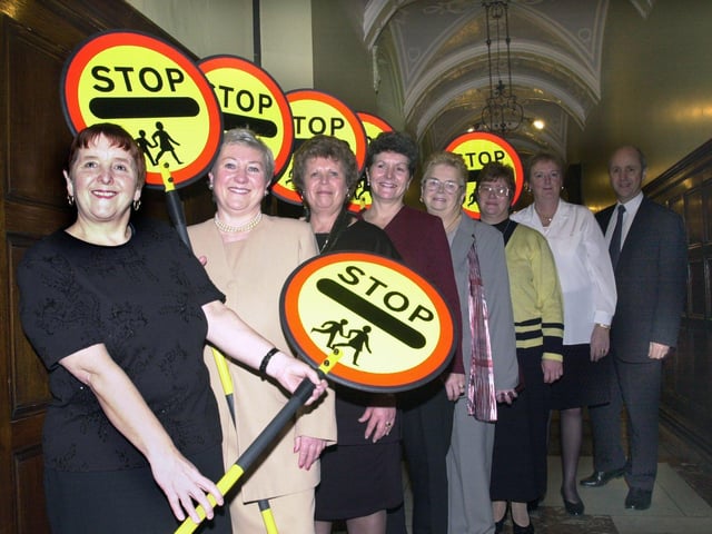 Long service presentation at County Hall for seven lollipop ladies in December 2000. Each lady had worked between 20 and 30 years helping pupils cross the roads before and after school. Pictured, from left, are Brenda Peach, Pat Brooks, Maureen Thorpe, Carol Bedford, Joan Baggley, Mary Hallas, and Ann Wilson. Also pictured is Jim Winter, assistant chief education officer, who made the presentations.