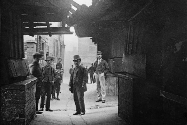 The Shambles circa 1887, showing the original wooden board 'fleshamols' (shelf flaps/window openings) of the butcher's shops. This street was named Shambles after the fleshamols on which butchers laid out their meat for sale in this area, in the 1400s.