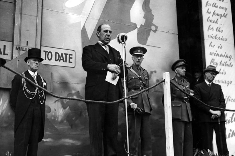 Opening ceremony for Salute the Soldier Week, making a speech is Sir John Anderton MP, who was then Chancellor of the Exchequer. On the left, wearing a top hat is Lord Mayor Albert Hayes. To the right of Sir John is Lord Harewood, then General Sir William Backstone.