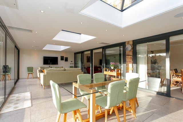 The garden room has bright and versatile space with doors leading outside to the gardens.