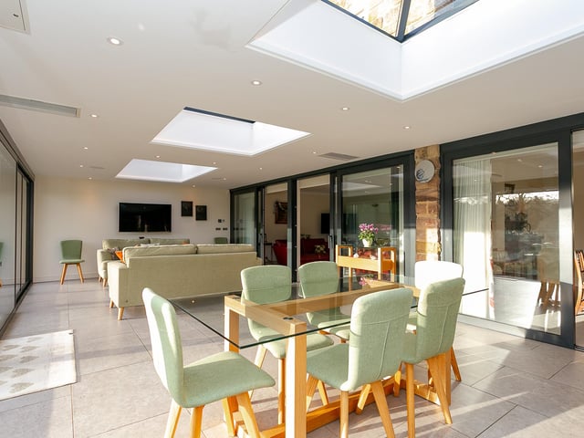 The garden room has bright and versatile space with doors leading outside to the gardens.