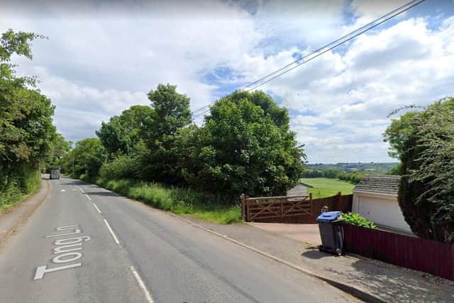 Police were called to a scene on Tong Lane after a paraglider had crashed landed.