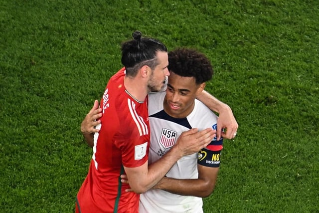 Adams hugs Wales forward Gareth Bale following the two countries' 1-1 draw in their Group B opener (Photo by Antonin THUILLIER / AFP) (Photo by ANTONIN THUILLIER/AFP via Getty Images)