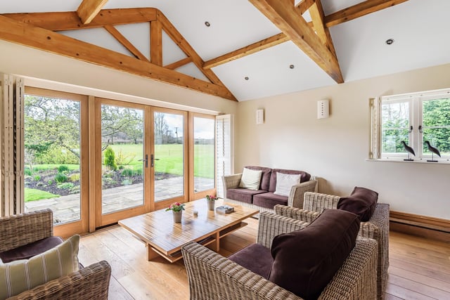 The garden room has a vaulted ceiling and French doors that open to the garden.