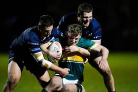Hunslet try scorer Mackenzie Turner is tackled by Swinton's Gavin Bennion and Mikey Wood. Picture by Olly Hassell/SWpix.com.