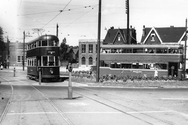 A view shows ex-Southampton tram no. 297 entering Easterly Road from Roundhay Road, while tram no. 269, a Middleton Bogie, is on the right, picking up passengers. The Yorkshire Penny Bank and the Co-operative Insurance Society are in the background on Roundhay Road. Pictured in July 1950.