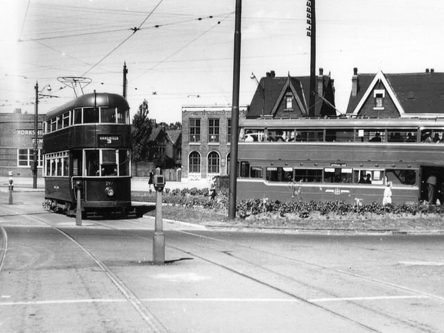A view shows ex-Southampton tram no. 297 entering Easterly Road from Roundhay Road, while tram no. 269, a Middleton Bogie, is on the right, picking up passengers. The Yorkshire Penny Bank and the Co-operative Insurance Society are in the background on Roundhay Road. Pictured in July 1950.