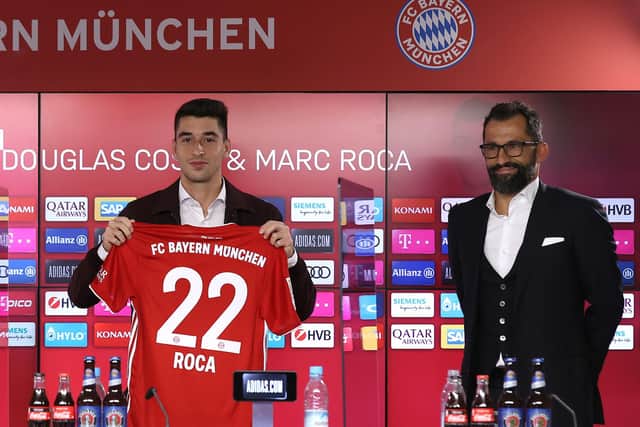 MUNICH, GERMANY - OCTOBER 13: Newly signed FC Bayern Muenchen players Douglas Costa (L) and Marc Roca pose next to Hasan Hasan Salihamidžić, sporting director of FC Bayern Muenchen after a virtual press conference at Säbener Strasse Training ground on October 13, 2020 in Munich, Germany. (Photo by Alexander Hassenstein/Getty Images for FC Bayern)
