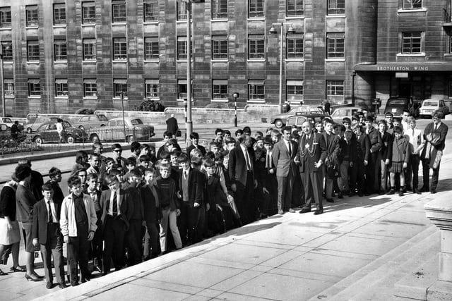 The Lord Mayor of Leeds, Joshua S. Walsh, meets a group of French and English boys outside Leeds Civic Hall in August 1966, one of the many events he attended during his Mayoral year of 1966-67. The Brotherton wing of Leeds General Infirmary can be seen in the background.