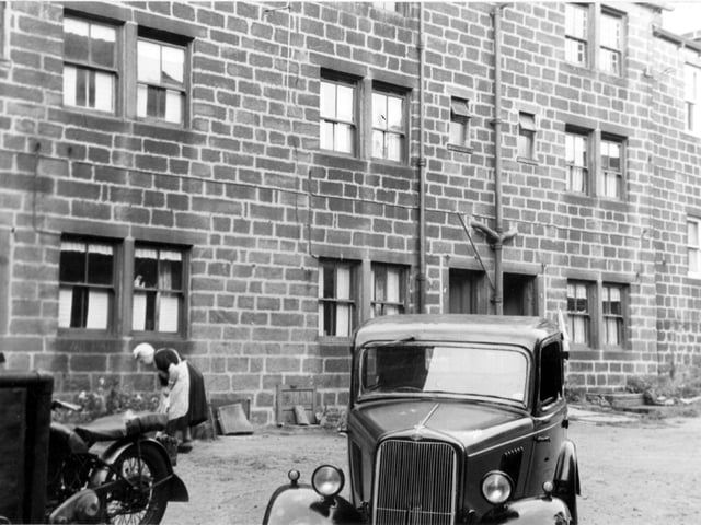 Taken in July 1955, this property on Starkey's Field was to be included in the council's five year slum clearance plan. This cleared area was used as site for Morrisons' supermarket. To the left a lady is tending her flowerbed.