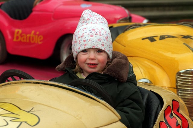 Charlotte Regan from Heckmondwike tries out one of the children's car rides at the Valentine's Fair in February 1997.
